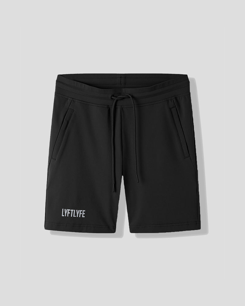 Black shorts with a brand logo on a light gray background