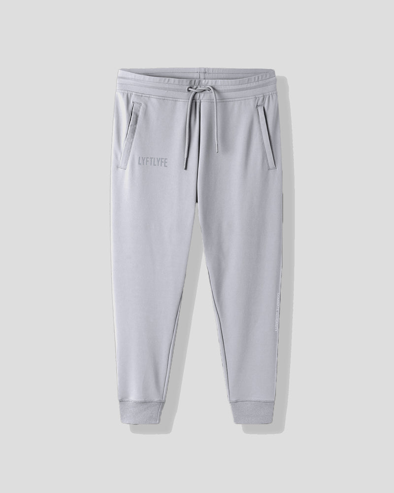 Light gray sweatpants with a brand logo on a white background