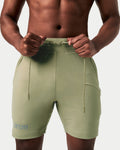 Close-up of green Breathe Shorts with reflective branding and ergonomic waistband design for comfort.