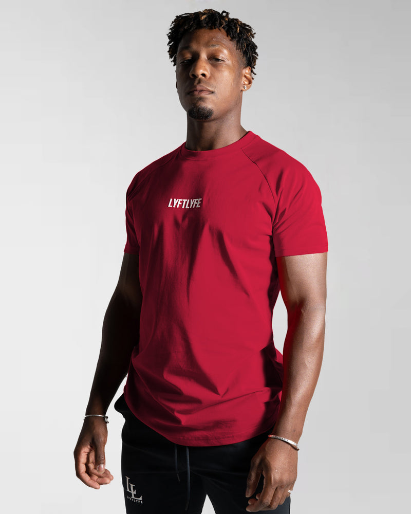 A male athlete wearing a red LYFTLYFE performance t-shirt.