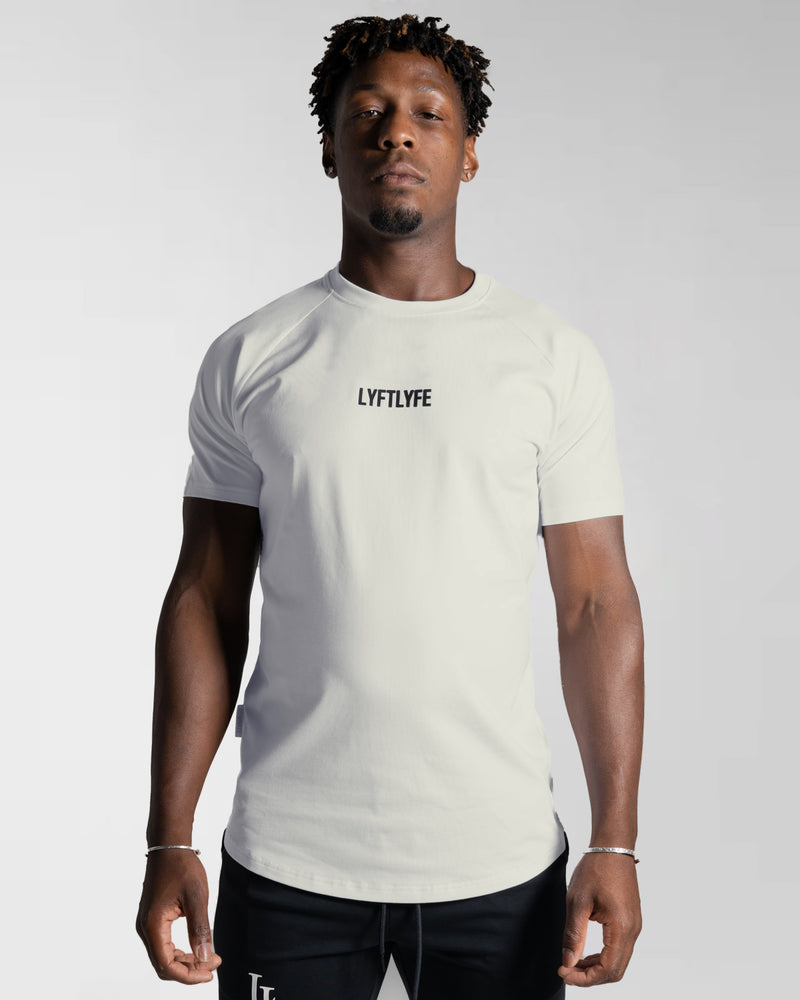 Men’s Contour T-Shirt in off-white, crafted with moisture-wicking fabric and a fitted cut for everyday movement.