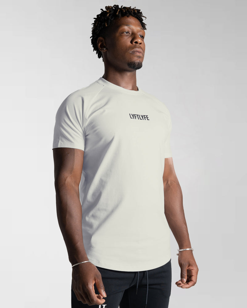 Men’s Contour T-Shirt in off-white, crafted with moisture-wicking fabric and a fitted cut for everyday movement.