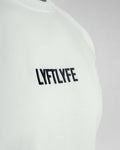 Detailed shot of the white LYFTLYFE logo on the off-white Contour Tee.