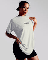 Oversized Contour Women’s Tee in off-white, featuring a moisture-wicking cotton blend and soft crew neckline for all-day comfort.