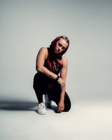 Women’s Dominance sleeveless hoodie in prune, highlighting a scoop hem, soft stretch fabric, and ergonomic fit.