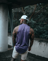 Men’s sleeveless tank top in purple, shown from the back, highlighting lightweight, wrinkle-resistant performance fabric. 