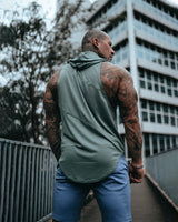 Back view of Men’s Dominance Sleeveless Hoodie in green, showcasing its breathable fabric and ergonomic fit with a relaxed hood.