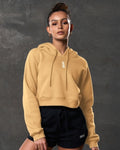 Yellow crop hoodie for women, shown from the front, with LYFTLYFE logo and ribbed cuffs.