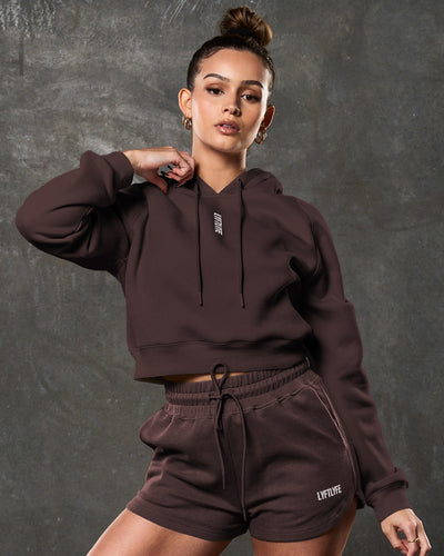 Dark brown crop hoodie for women, with a white LYFTLYFE logo and ribbed cuffs.