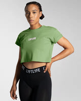 Left side view of the Women’s Drill Crop Tee in green, offering cooling properties, premium stitching, and all-day comfort.