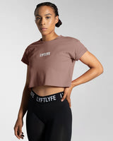 Left side view of the Women’s Drill Crop Tee in rose color, offering cooling properties, premium stitching, and all-day comfort.