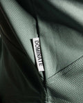Detailed shot of Lyftlyfe’s slogan Dominate Adversity tag on Women’s gym hoodie in green, crafted for durability and performance.