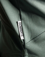 Detailed shot of Lyftlyfe’s slogan Dominate Adversity tag on Women’s gym hoodie in green, crafted for durability and performance.