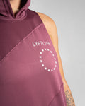 Detailed shot of Lyftlyfe branding on Women’s gym hoodie in prune, designed with antibacterial and sweat-wicking fabric.
