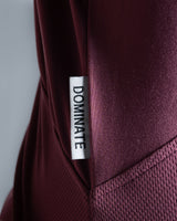 Detailed shot of Lyftlyfe’s slogan Dominate Adversity tag on Women’s gym hoodie in prune, crafted for durability and performance.