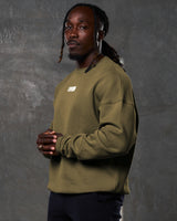 Left side view of men’s Adapt Crew in green with relaxed fit, ribbed detailing, and lightweight fleece material for all-day wear.