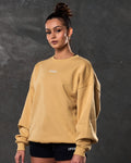Left side view of women’s yellow oversized crewneck with ultra-soft fleece fabric, ribbed hem, and relaxed fit.