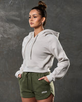 Sand cropped fleece hoodie left side angle highlighting sleek athletic cut.