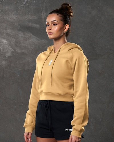 Yellow crop hoodie for women, shown from the front, with LYFTLYFE logo and ribbed cuffs.