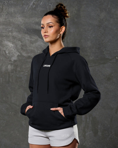 Women's black full-length hoodie with center LYFTLYFE logo and drawstrings.