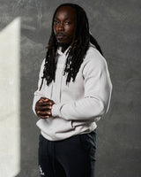 Left side view of LYFTLYFE hoodie in white sand showing sleeve fit and minimal branding.