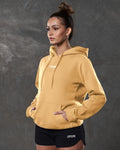 Left side view of yellow hoodie showing kangaroo pocket and tonal drawstrings.