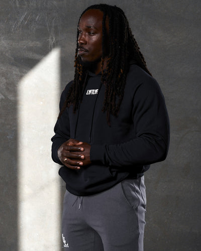 Men's black Elite LYFTLYFE hoodie front view with centered white logo and drawstrings.