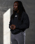 Elite hoodie in black shown from the left side, highlighting clean design and comfort fit.