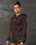 Left side view of women’s dark brown hoodie with tonal drawstrings and fitted sleeves.