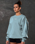Women’s light blue Adapt Crew, side angle showcasing breathable fleece fabric  and clean ribbed detailing.