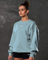 Women’s light blue Adapt Crew, side angle showcasing breathable fleece fabric  and clean ribbed detailing.
