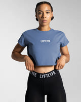 Women’s Drill Crop Tee in blue, offering cooling properties, premium stitching, and all-day comfort.