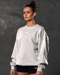 Left side view of women’s sand (off-white) Adapt Crew featuring a relaxed oversized fit, centered Lyftlyfe chest logo, and soft fleece fabric.