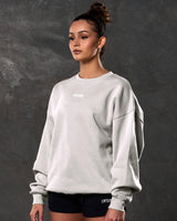 Left side view of women’s sand (off-white) Adapt Crew featuring a relaxed oversized fit, centered Lyftlyfe chest logo, and soft fleece fabric.