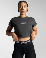 Drill Women’s Crop T-shirt in dark grey, showcasing its fitted cut, soft-stretch fabric, and moisture-wicking properties.