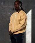 Men’s yellow Adapt Crew, left side angle showcasing plush fabric, ribbed hem, and oversized design for casual wear.