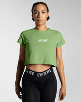 Front-facing view of the Women’s Drill Crop Tee in green, offering cooling properties, premium stitching, and all-day comfort.