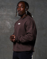 Left view of Men’s ultra-soft dark brown crewneck sweater with oversized fit, cotton-polyester blend, and a white Lyftlyfe logo on the chest. 