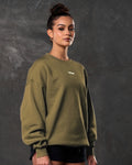 Women’s oversized green crewneck sweater, shown from the right side, with plush fabric and ribbed detailing for casual wear.