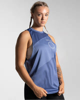 Right side view of Women’s Dominance Cut Sleeve tank top in blue, featuring lightweight tri-blend fabric with antibacterial and anti-odor technology.