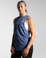 Left side view of Women’s Dominance Cut Sleeve tank top in blue, featuring lightweight tri-blend fabric with antibacterial and anti-odor technology.