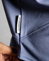 Close-up of Dominate Adversity tag on the side hem of Women’s Dominance Cut Sleeve tank in blue, stitched for durability.