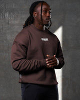 Right view of Men’s ultra-soft dark brown crewneck sweater with oversized fit, cotton-polyester blend, and a white Lyftlyfe logo on the chest. 