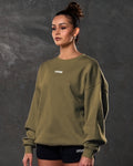 Women’s oversized green crewneck sweater, shown from the left side, with plush fabric and ribbed detailing for casual wear.