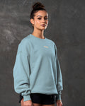 Women’s light blue Adapt Crew, side angle showcasing breathable fleece fabric, clean ribbed detailing and a white Lyftlyfe logo.
