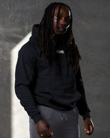 Elite hoodie in black shown from the right side, highlighting clean design and comfort fit.