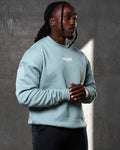 Right side view of men’s light blue oversized crewneck with ultra-soft fleece, ribbed cuffs, and a relaxed, comfortable fit.