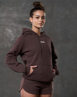 Right side view of brown hoodie showing kangaroo pocket and tonal drawstrings.