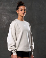 Right side view of women’s sand (off-white) Adapt Crew featuring a relaxed oversized fit, centered Lyftlyfe chest logo, and soft fleece fabric.