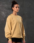 Right side view of women’s yellow oversized crewneck with ultra-soft fleece fabric, ribbed hem, and relaxed fit.